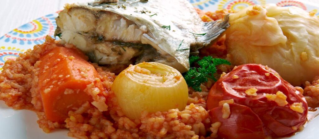 Grilled fish served with rice and roasted onion.