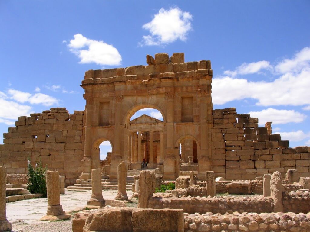 Ancient stone ruins under a bright blue sky.