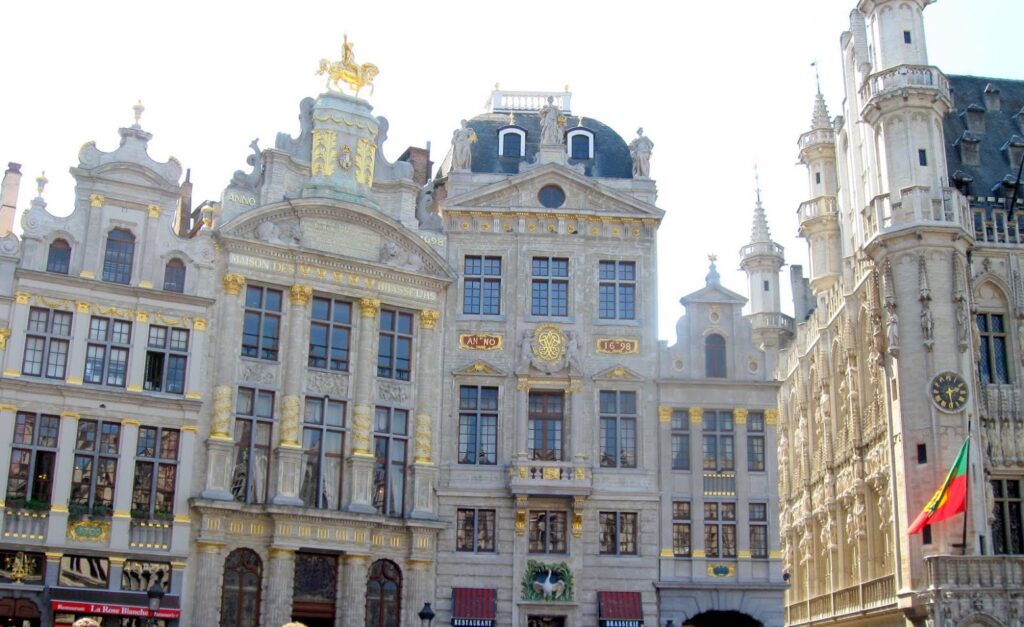 Historic buildings with ornate architecture in a European city square.