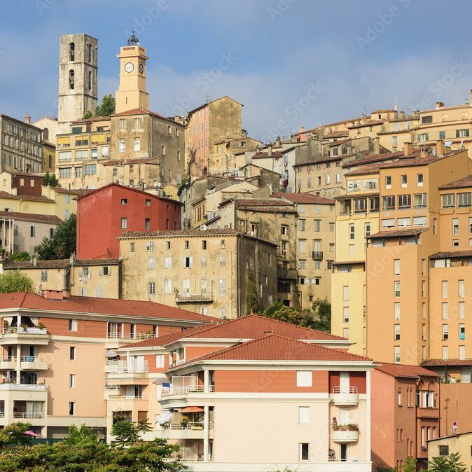 A hillside town with colorful buildings under a clear sky.