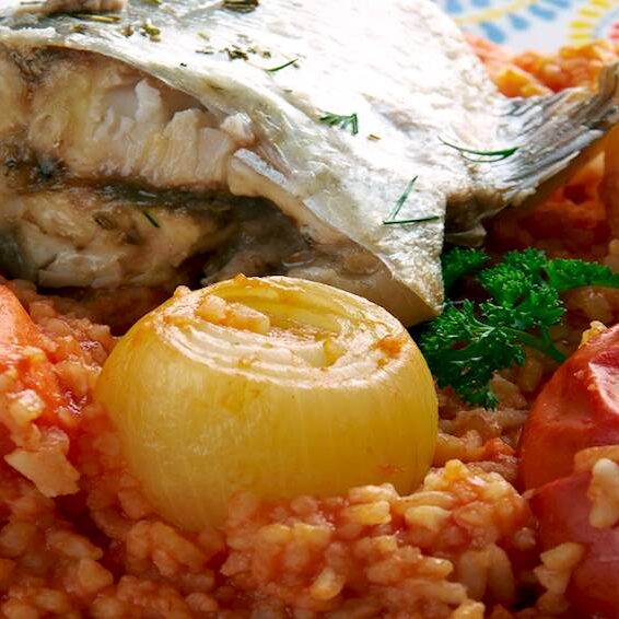 Grilled fish served with rice and roasted onion.