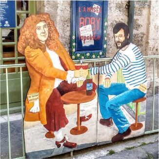 Mural of a man and woman sharing drinks at a small table.